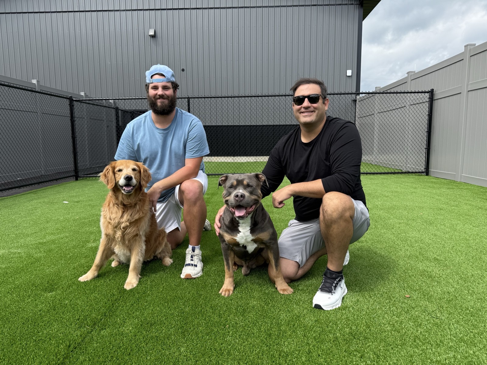 Barkingham Palace founders Chad Kaiser and Jack Carney with Bentley and Callie in the real outdoor turf yard at the Rotterdam facility