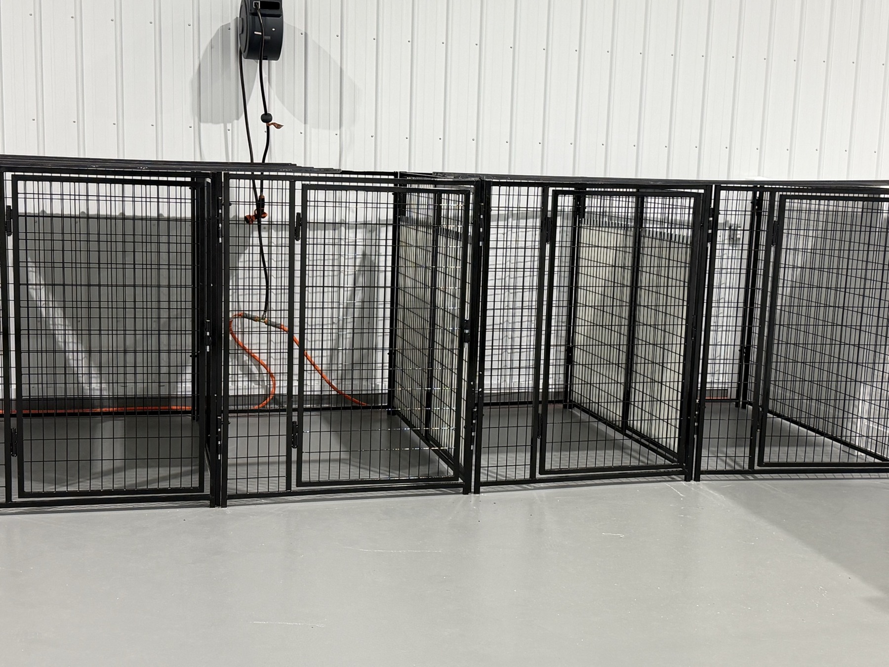 Dog boarding near me in Rotterdam, NY, with adjoining black metal sleeping suites inside Barkingham Palace