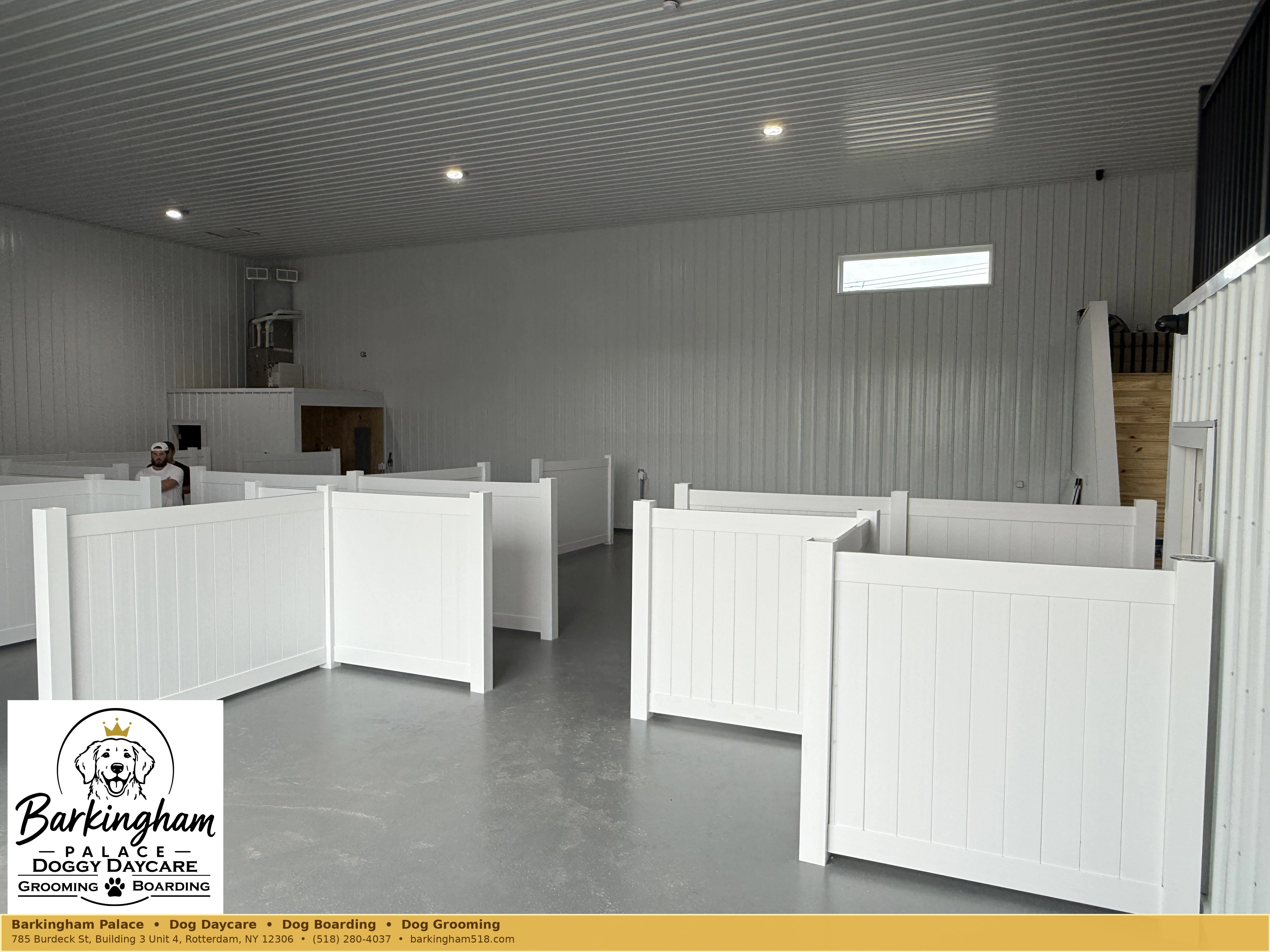 Bright interior dog-care space with clean white partitions at Barkingham Palace in Rotterdam, NY